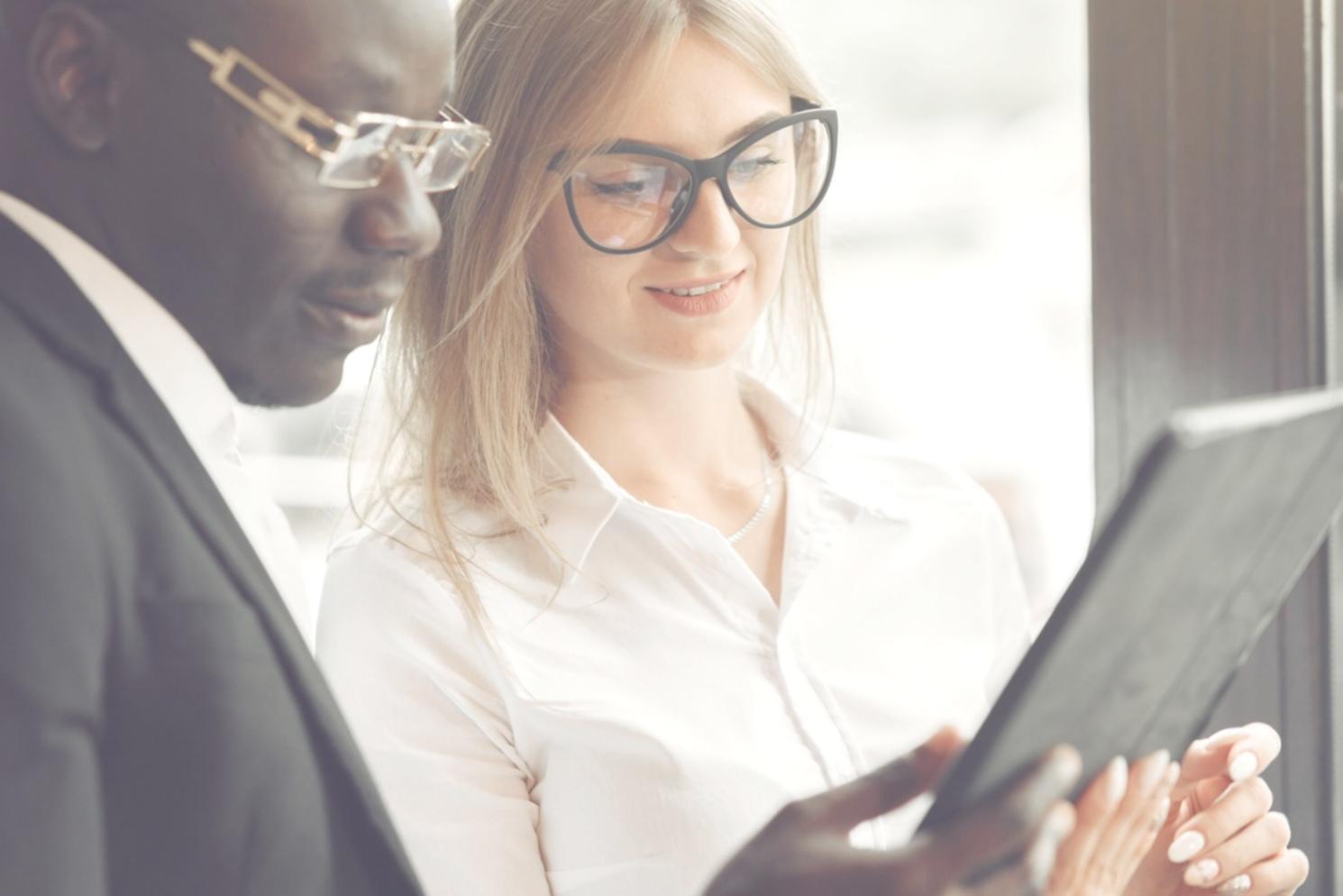 Financial charts and market analysis documents spread across desk