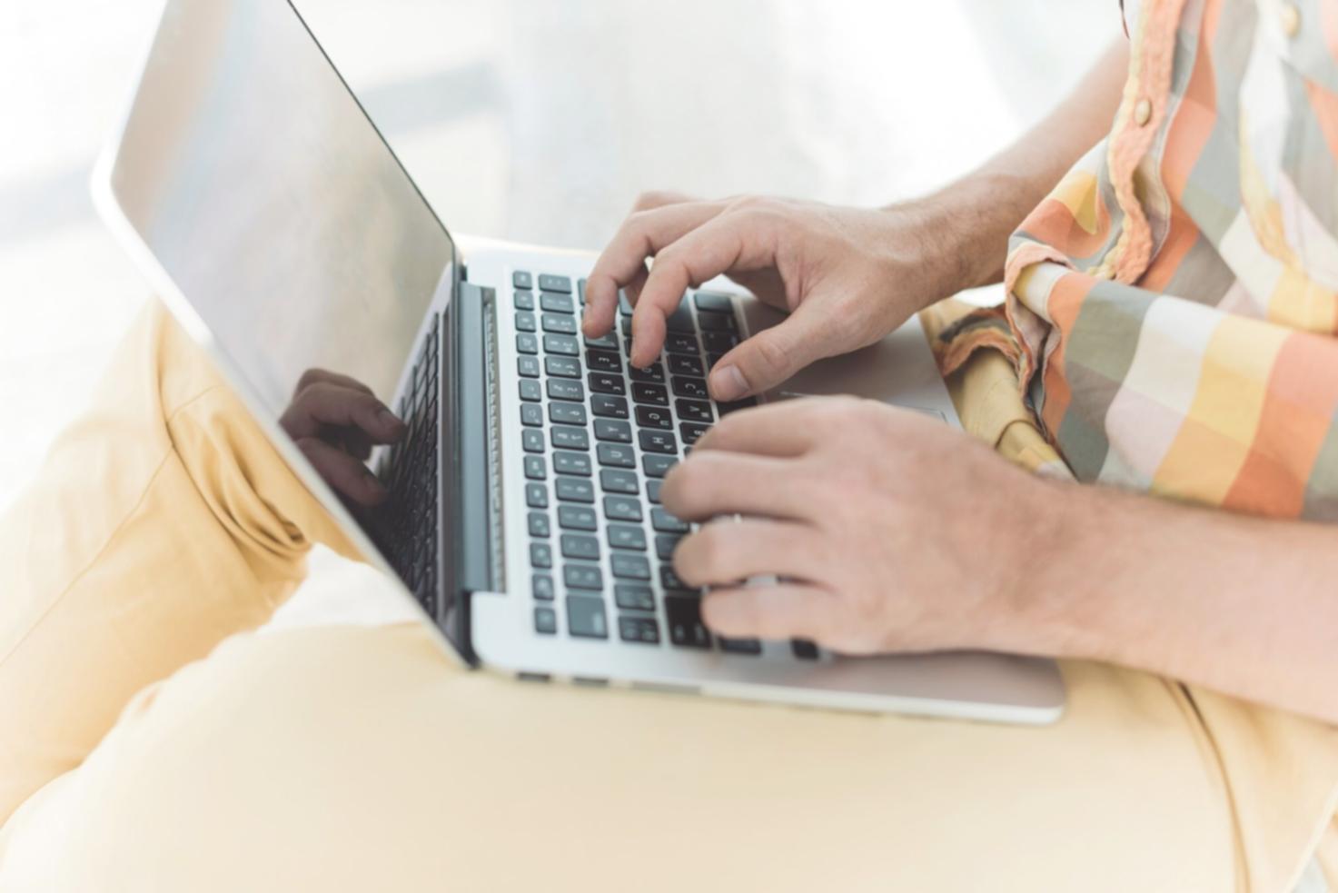 Investment workshop participants analyzing market data on laptops